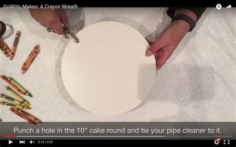 A Person Is Making A Cake With Crayons On The Table Next To It