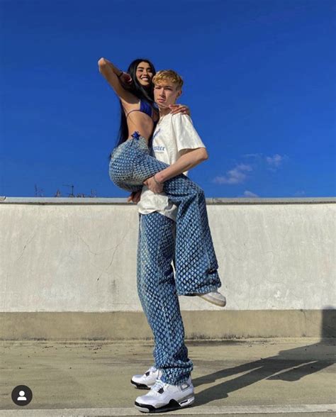 Two People Are Posing For A Photo On A Skateboard