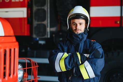 Premium Photo Fireman Firefighter In Action Standing Near A Firetruck