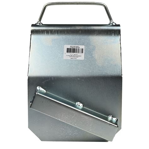 A Metal Box With Two Handles And Bar On The Front Sitting Against A