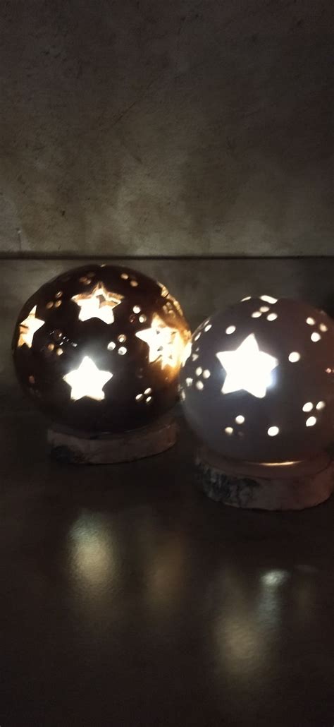 Two Decorative Lights Sitting On Top Of A Table