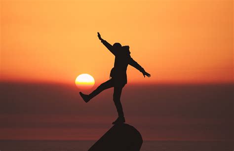 Online Crop Silhouette Photo Of A Person Standing On Stone During