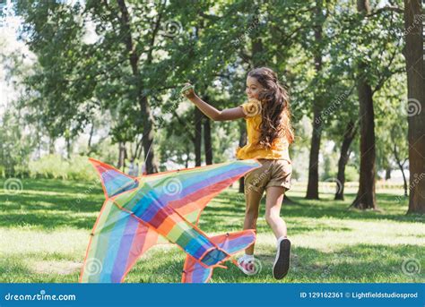 Cute Happy Kid Playing With Colorful Kite And Running Stock Image