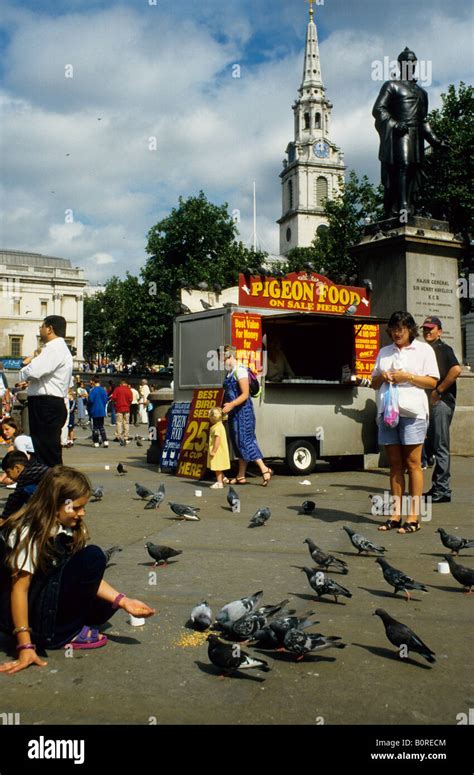 Feeding the pigeons, Trafalgar Square, London Stock Photo - Alamy