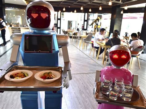 Robots Named Xiaolan And Xiaotao Which Their Designers Built To Be A