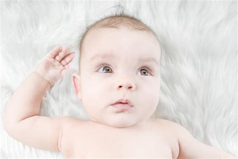 Premium Photo Cute Baby Lying On A White Fur