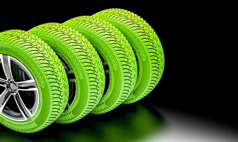 Ecological Green Tires On Dark Background Photograph By Gualtiero