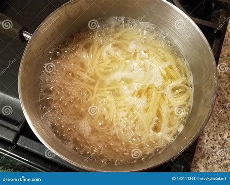 Spaghetti Cooking In Boiling Water In Pot On Stove Stock Image Image