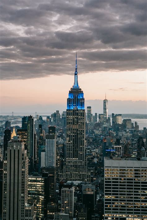 Empire State Building under cloudy sky in city · Free Stock Photo