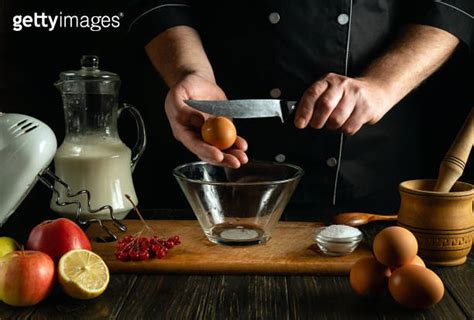 The Cook Prepares An Egg Omelette With Milk In The Kitchen Of A Breakfast Restaurant Work