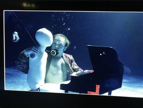 A Man Sitting In Front Of A Laptop Computer Under Water