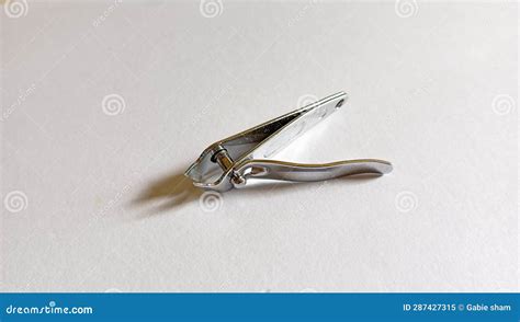 Elegant Steel Nail Clippers With A Pointed Tip Placed On A Clean White