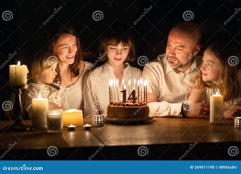 Cute Fourteen Years Old Girl Making A Wish Before Blowing Candles On