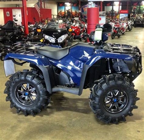 A Blue Four Wheeler Is Parked In A Showroom