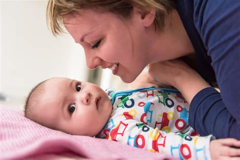 young mother kissing her cute little baby 12650875 Stock Photo at Vecteezy