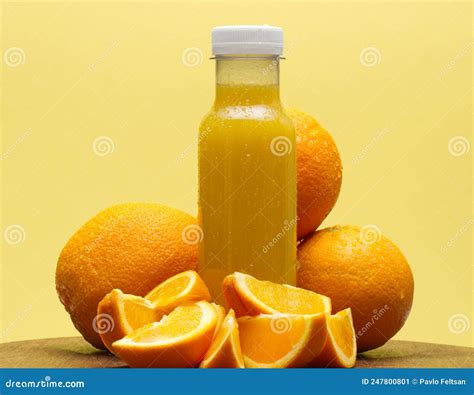 Frasco De Jugo De Naranja Aislado En Fondo Amarillo Imagen De Archivo