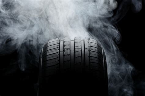 Premium Photo | Car tire and smoke on black