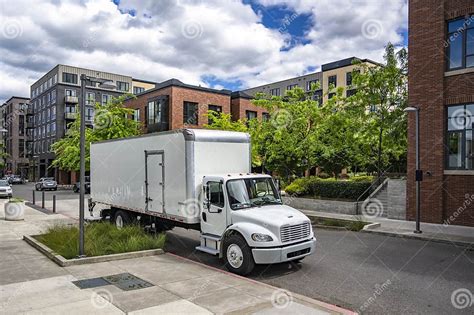 Day Cab Middle Duty Rig Semi Truck With Box Trailer Making Delivery Standing On The Urban Street