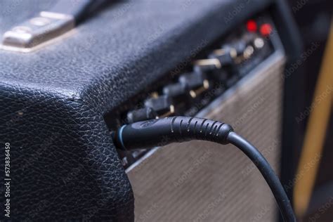 plug jack  cable plugged   black guitar combo amplifier stock