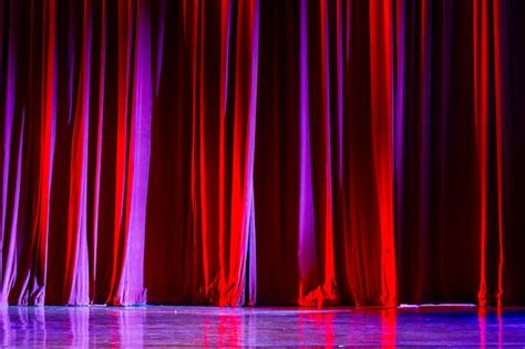 Premium Photo | Red curtains and the spotlight in the theater between ...