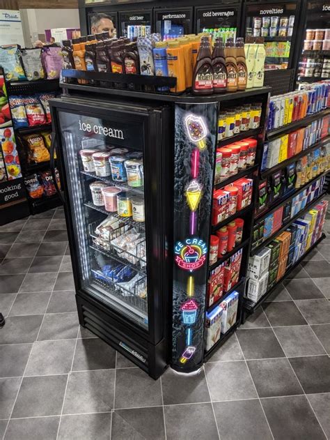 A Display Case In A Grocery Store Filled With Drinks And Snacks For