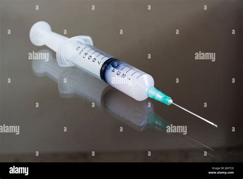 Liquid In The Syringe On The Table Stock Photo Alamy