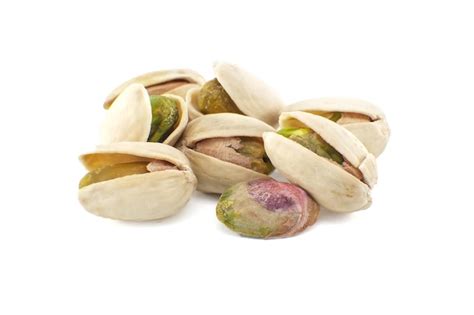 Premium Photo Pistachios Spread Across The White Surface Some