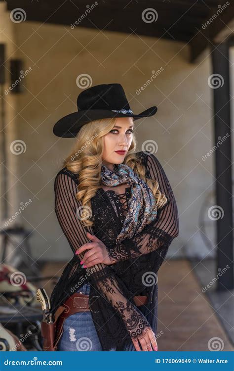 A Lovely Blonde Model Dressed As A Cowgirl Enjoys The American West