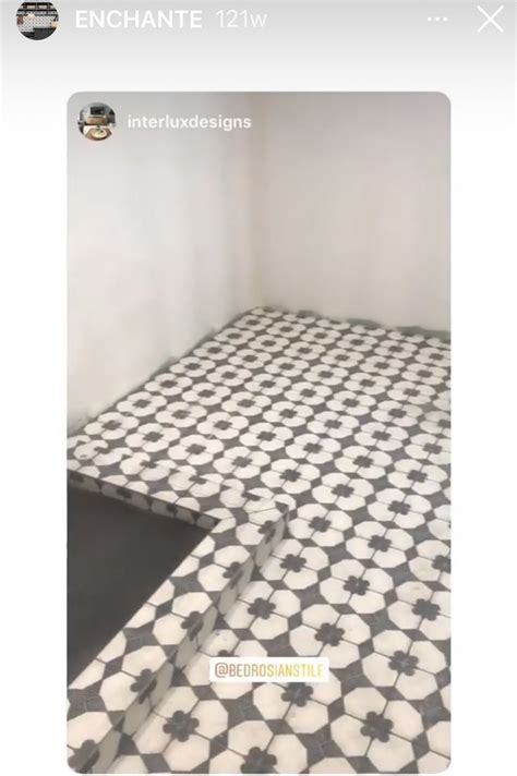 An Empty Room With Black And White Tiles On The Floor