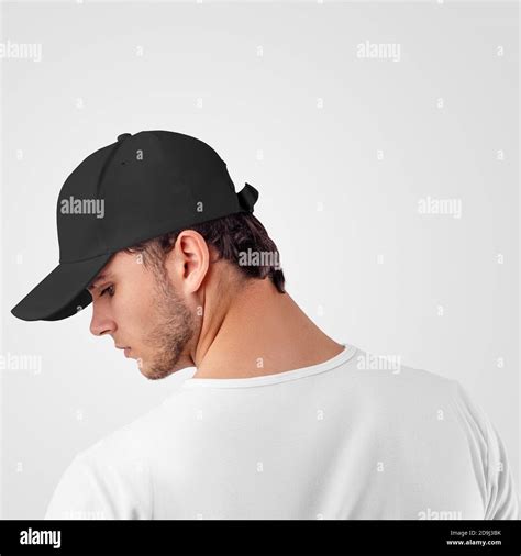 Mockup Of A Black Baseball Cap On A Guy Standing Backwards For The Presentation Of Design