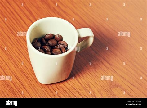 White Espresso Cup With Coffee Beans On The Wooden Table Horeca