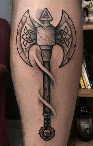 A Tattoo On The Leg Of A Man With An Old Style Hammer And Sickle