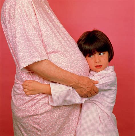 Pregnant Woman With Her Daughter Listening Photograph By Alex Bartel