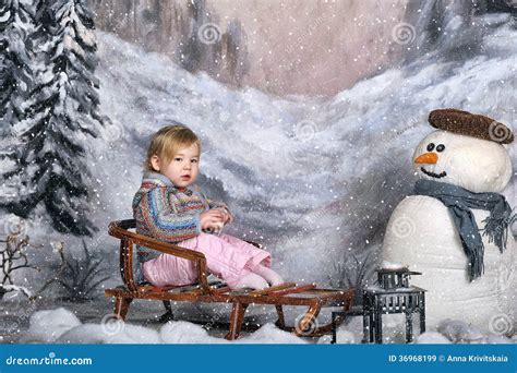 Girl On A Sled Next To A Snowman Stock Image Image Of Cheerful Fall