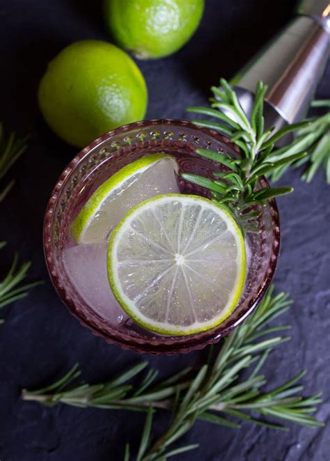 Top View Of Gin And Tonic Cocktail Lime Slices Ice Rosemary Pink