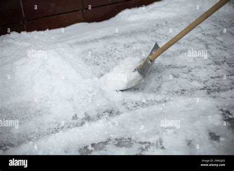 Snow Removal On Street Shovel For Track Cleaning Man Cleans Up Yard