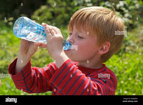 young boy drinking water from a bottle Stock Photo - Alamy