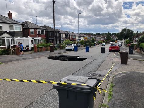 Huge Sinkhole Becomes Tourist Attraction In Manchester After Sewer Collapse