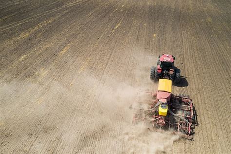 Premium Photo Top View Of Tractor Planting Corn Seed In Field High