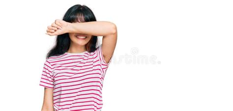 Young Hispanic Girl Wearing Casual Clothes Covering Eyes With Arm