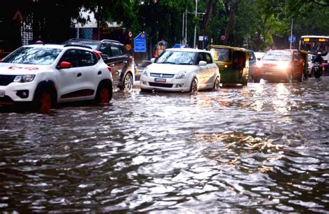 Bengaluru Vehicles Wade Through A Waterlogged Road After Heavy Rainfall