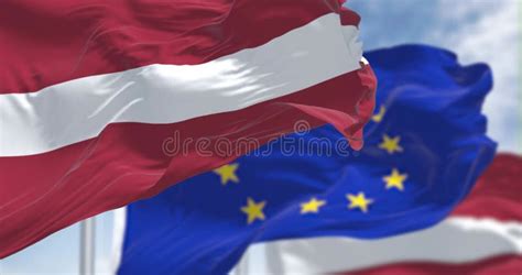 Detail Of The National Flag Of Latvia Waving In The Wind With Blurred