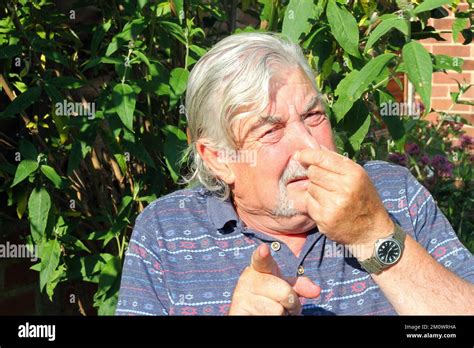 Senior Or Elderly Man Holding Nose Because Of A Bad Smell And Pointing