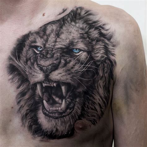 a man's chest with a lion tattoo on it