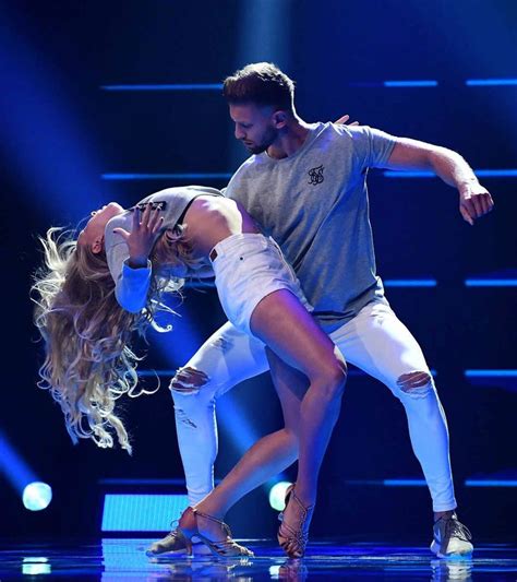 A Man And Woman Are Dancing On Stage