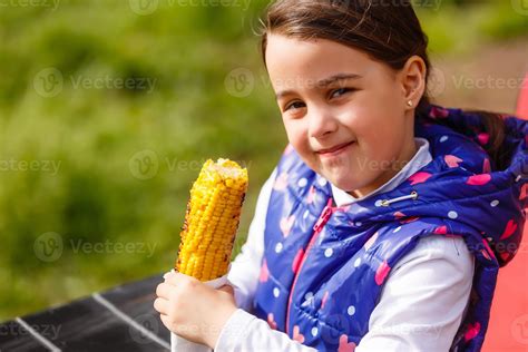 Cute Little Girl Eating Corn In Summertime 16477296 Stock Photo At Vecteezy