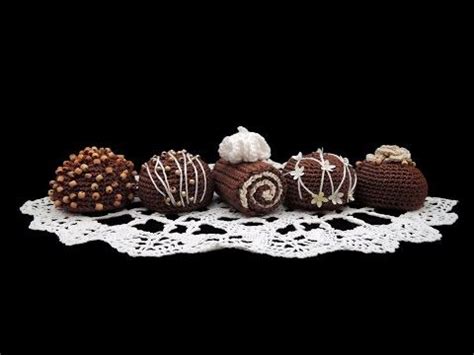 Chocolates Are Arranged On A Lace Doily With White Crochet Around Them