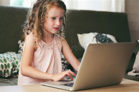 Happy Child Using Laptop At Home School Girl Learning With Computer