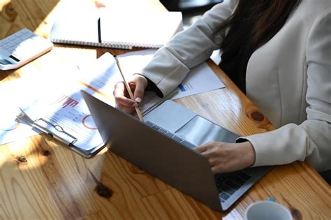 Premium Photo Cropped Shot Businesswoman Checking Reports And Using