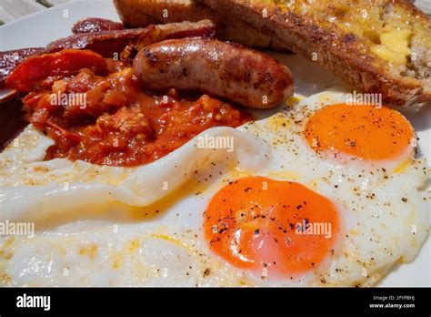 Full English Breakfast With Two Eggs And A Sausage Hi Res Stock